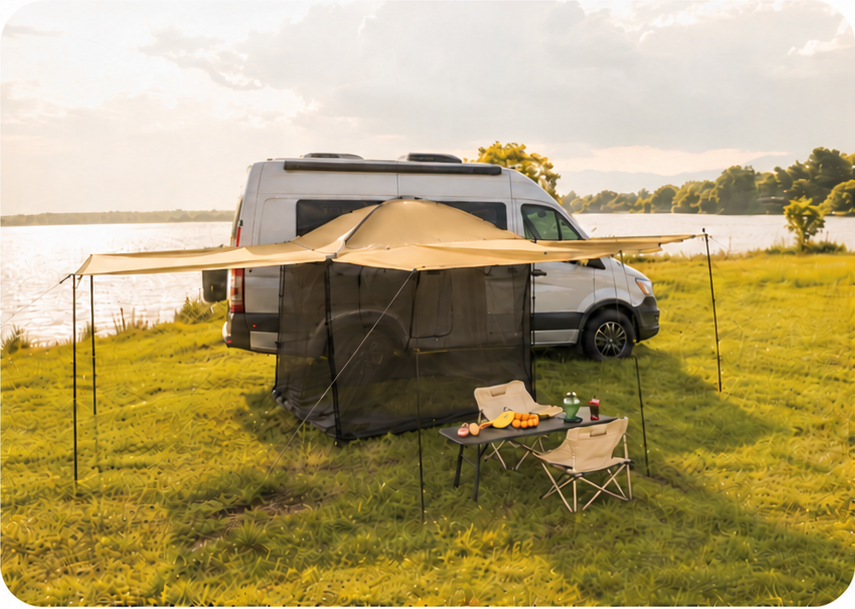 White camper van with a full awning shelter and camping furniture beside a lake